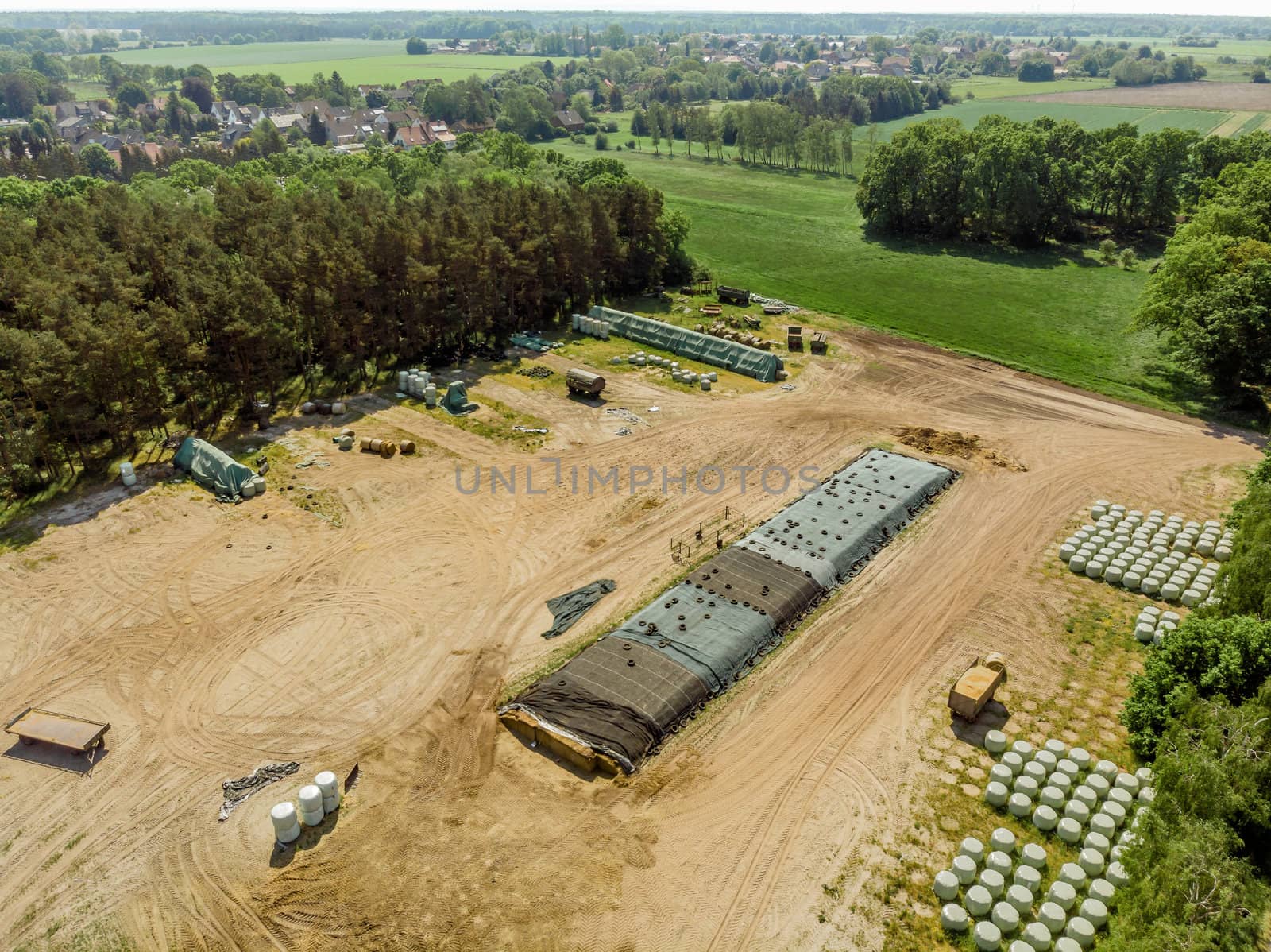 Aerial view of a farm camp, diagonal view of a large silage heap, made with drone