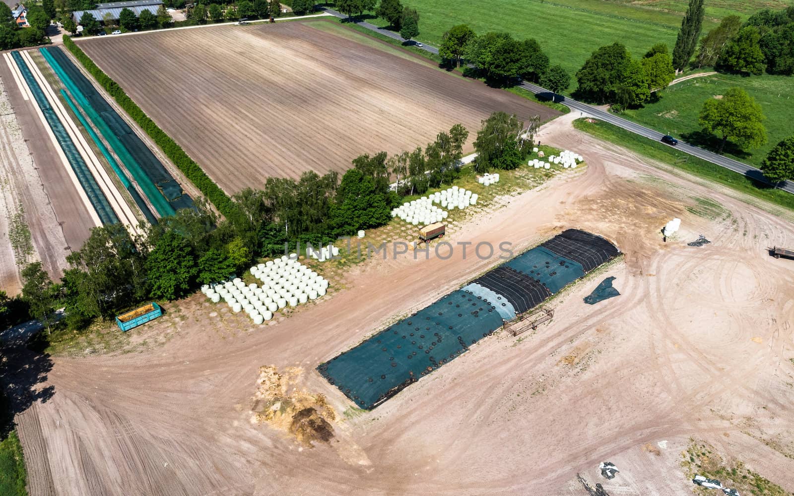 Aerial view of a farm camp, diagonal view of a large silage heap, made with drone