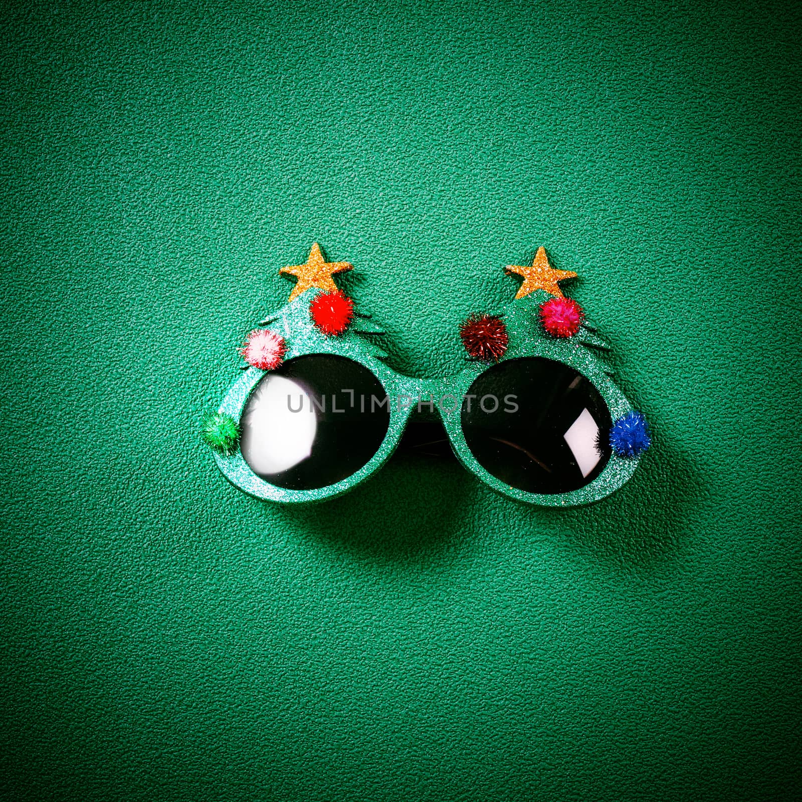Christmas glasses that decoration with Christmas tree and red ball on green background