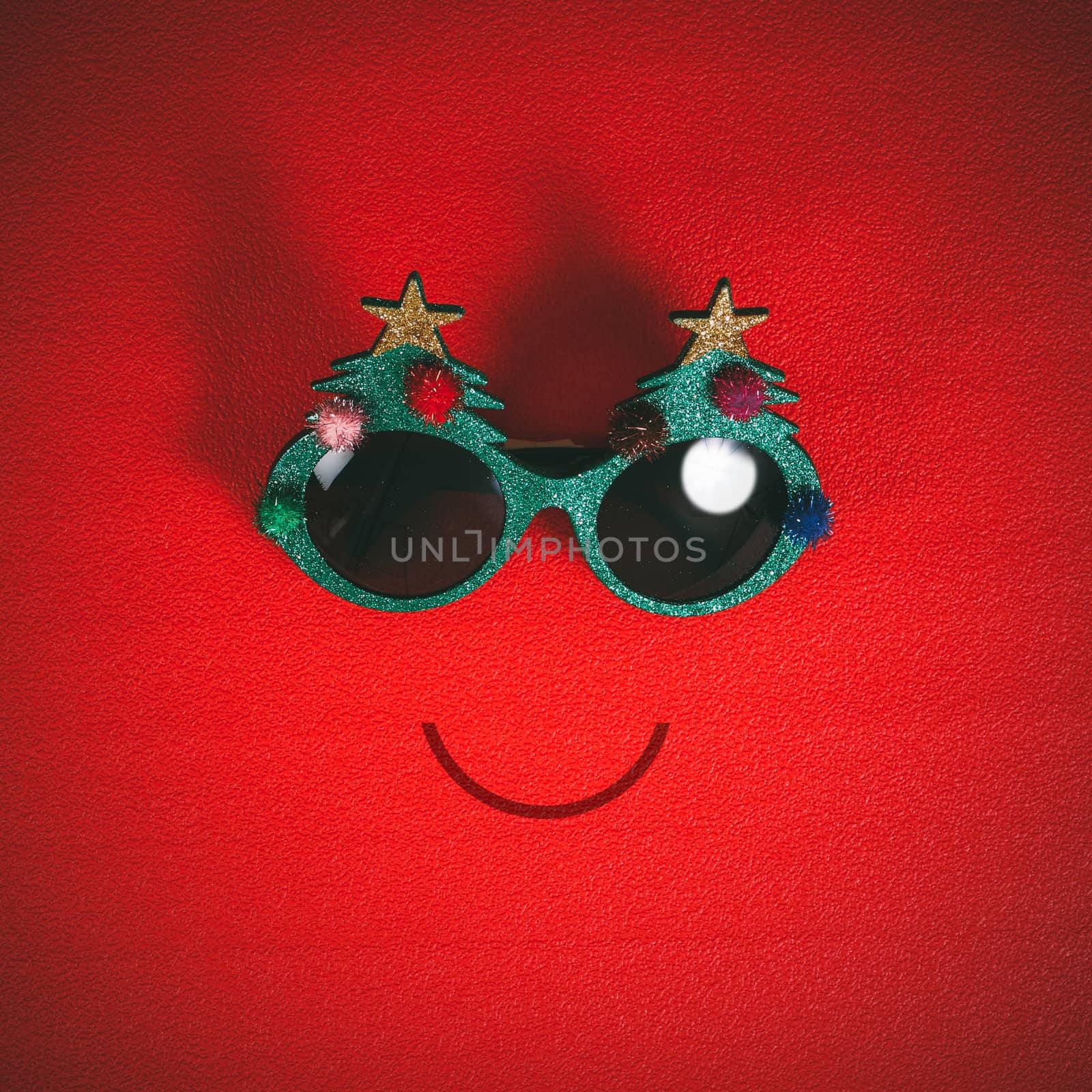 Christmas glasses that decoration with Christmas tree and red ball on red background