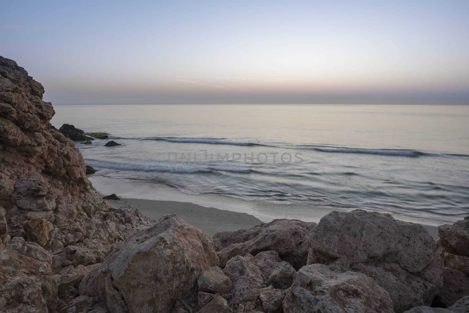 Sunrise over cliffs and sea of Oman (Gulf of Oman) wild coast of Ras Al Jinz, Sultanate of Oman