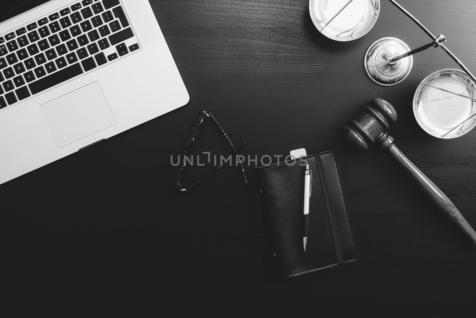 justice and law concept.Lawyer workplace with laptop and documents with dark wooden,black and white