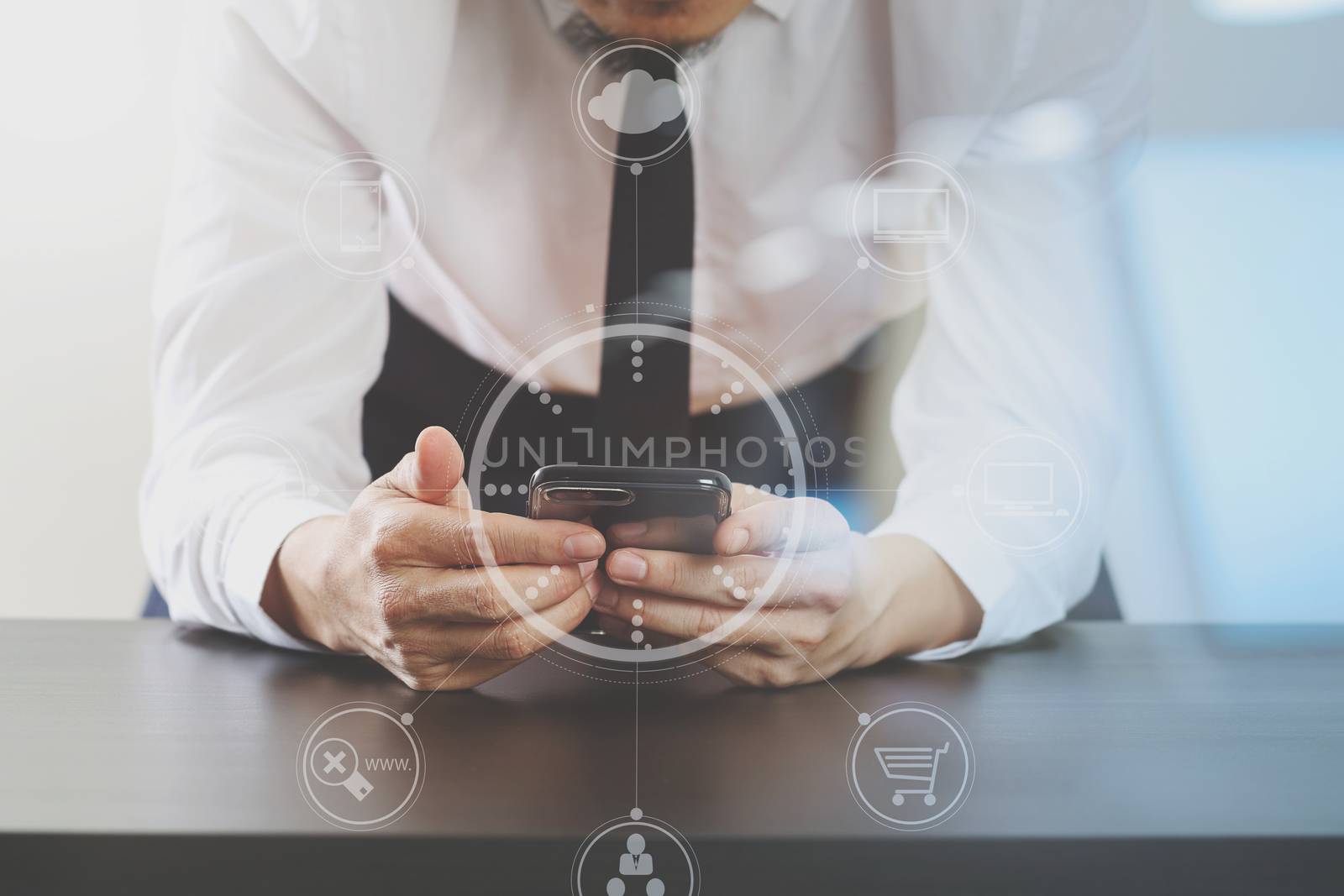 close up of businessman working with smart phone on wooden desk in modern office with virtual icon diagram