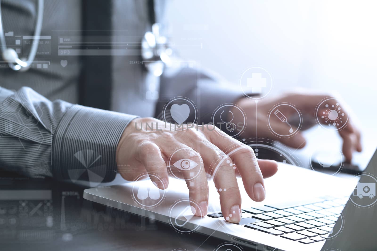 close up of smart medical doctor working with laptop computer and mobile phone and stethoscope on dark wooden desk with virtual reality icon diagram