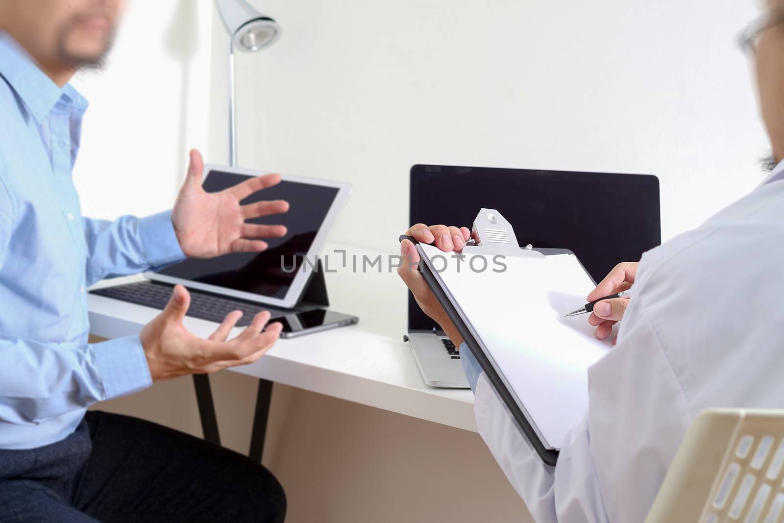 Medical doctor in white uniform gown coat consulting businessman patient having exam as Hospital professionalism concept 