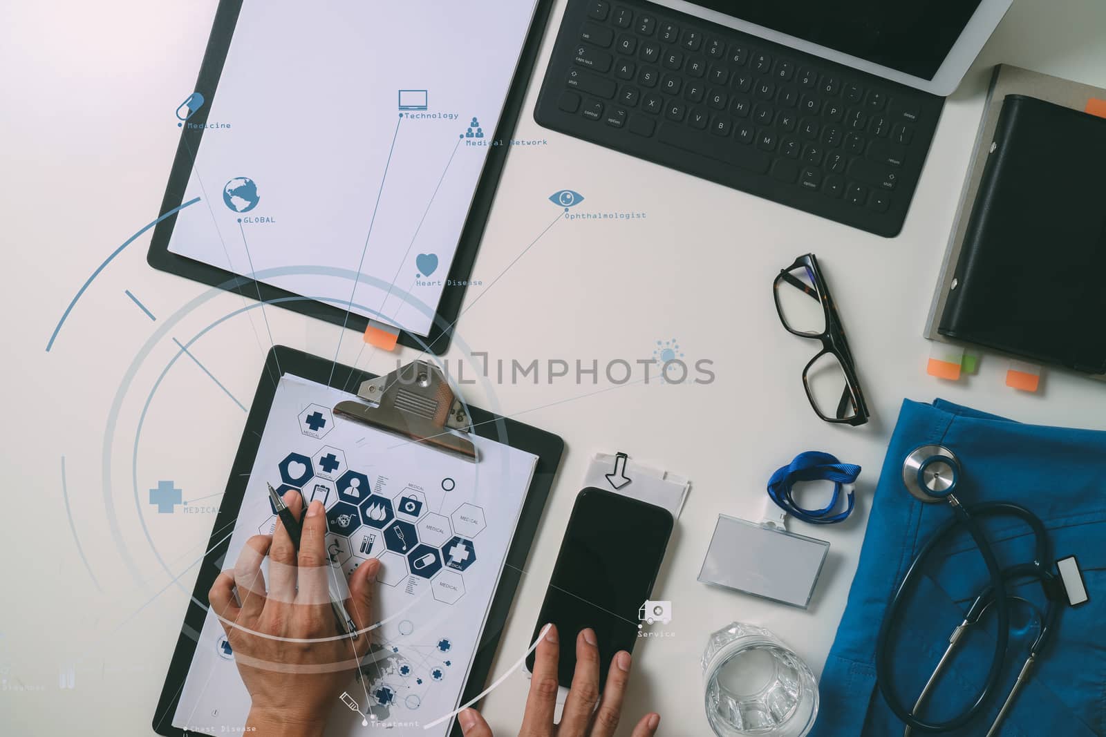 top view of smart medical doctor working with mobile phone and laptop computer and stethoscope on dark wooden desk with virtual reality icon diagram 