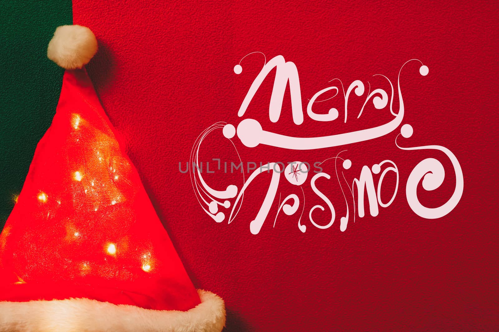 Greeting Season concept.Santa Claus hat with christmas light on red and green background