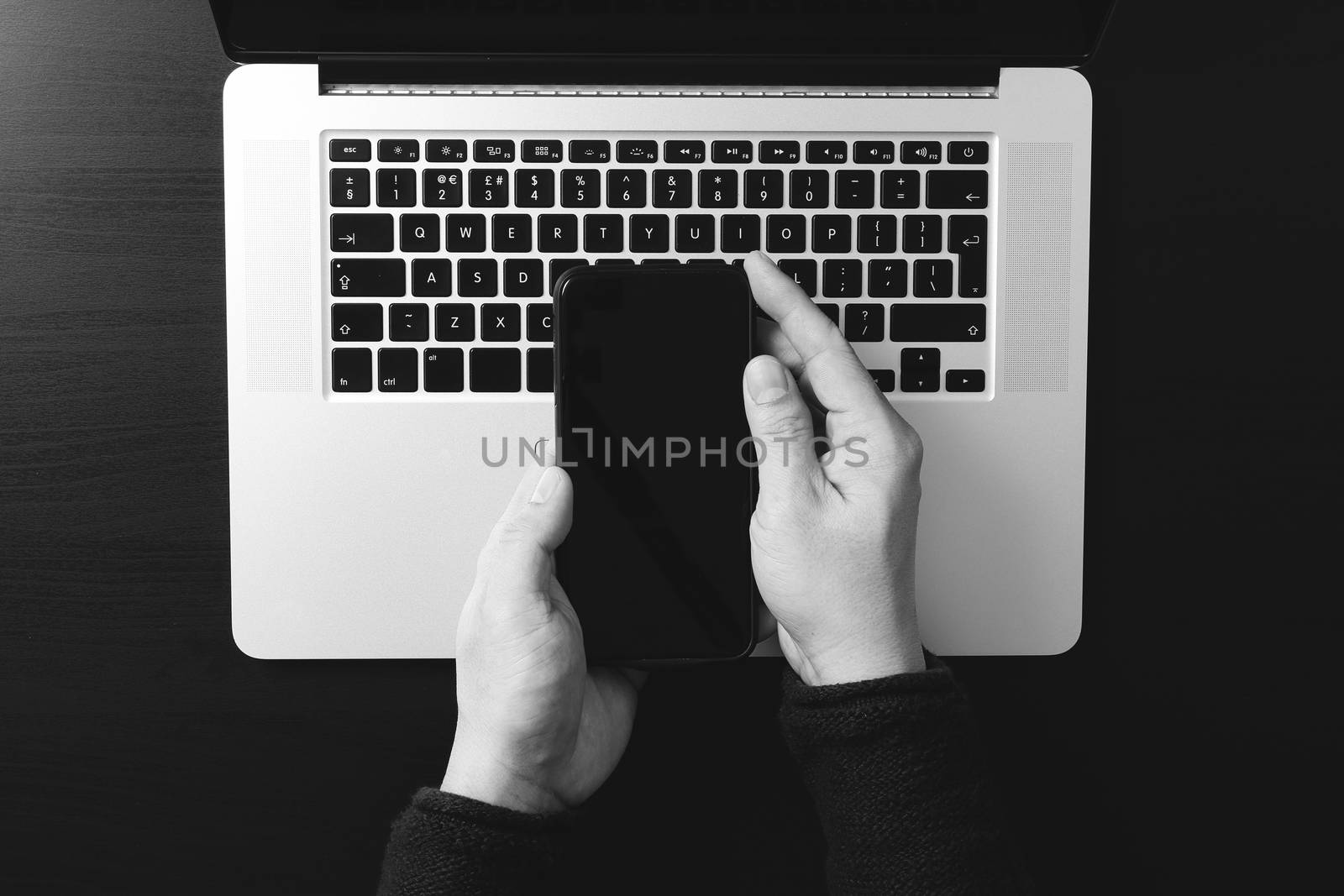 cyber security internet and networking concept.Businessman hand working with VR screen padlock icon mobile phone on laptop computer,black and white