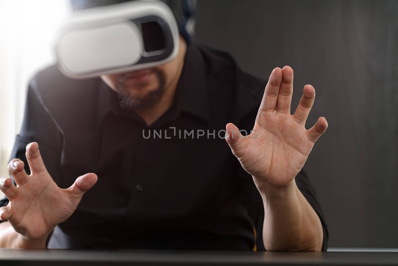 businessman wearing virtual reality goggles in modern office wit by everythingpossible