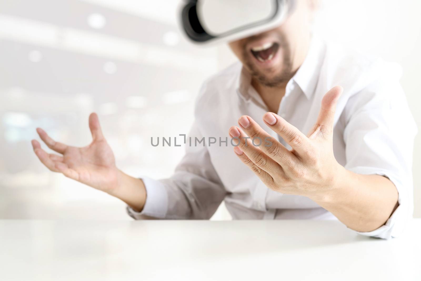 businessman wearing virtual reality goggles in modern office wit by everythingpossible