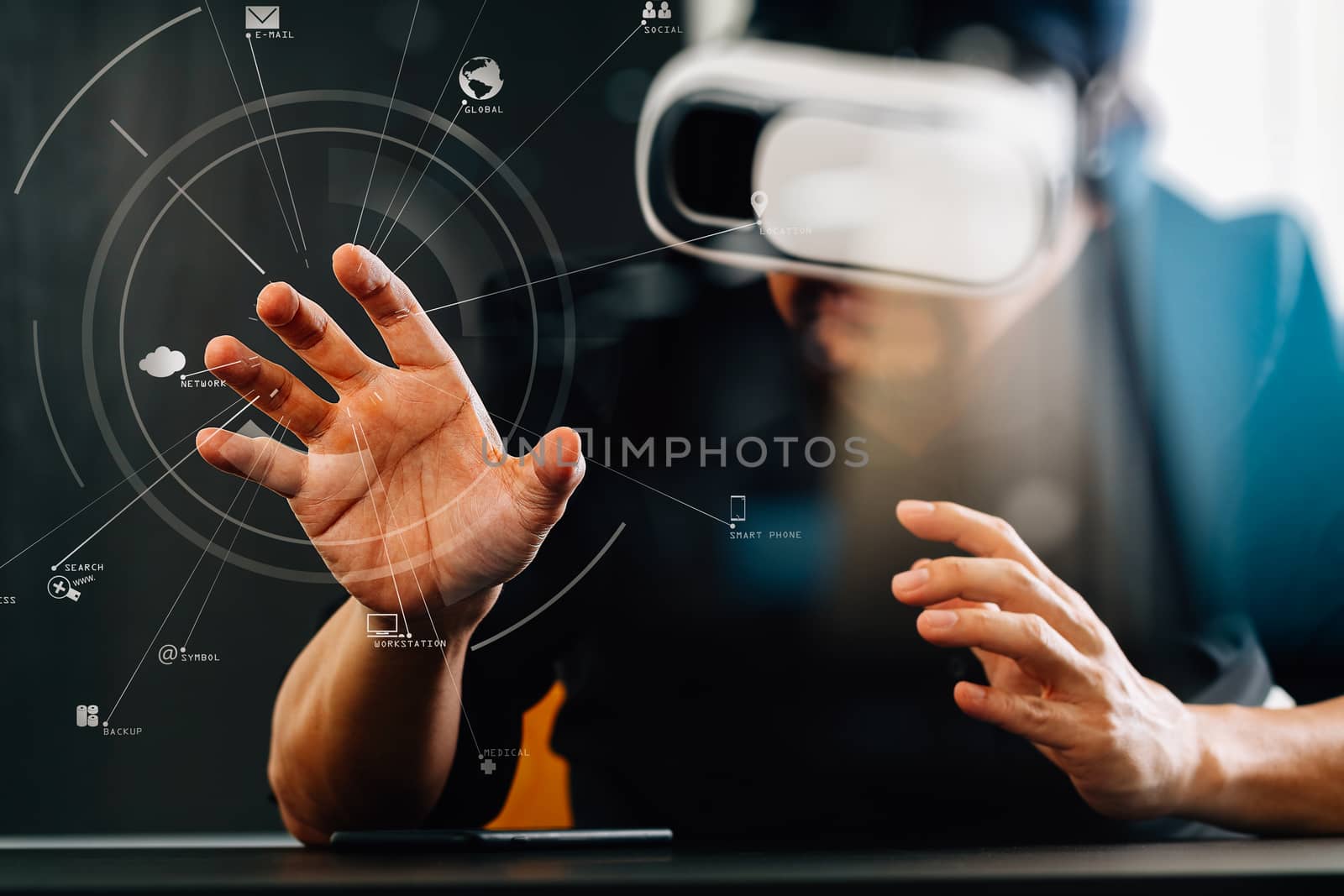 businessman wearing virtual reality goggles in modern office with mobile phone using with VR headset with screen icon diagram