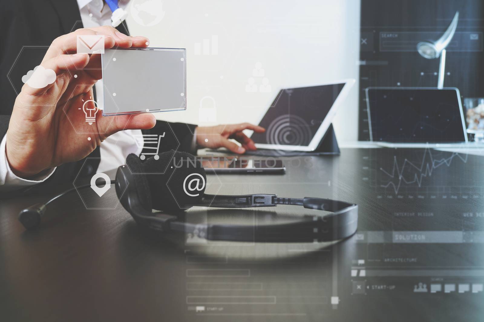 Man using VOIP headset and show id tag with digital tablet and laptop computer as concept communication,it support,call center and service help desk  with virtual icon diagram