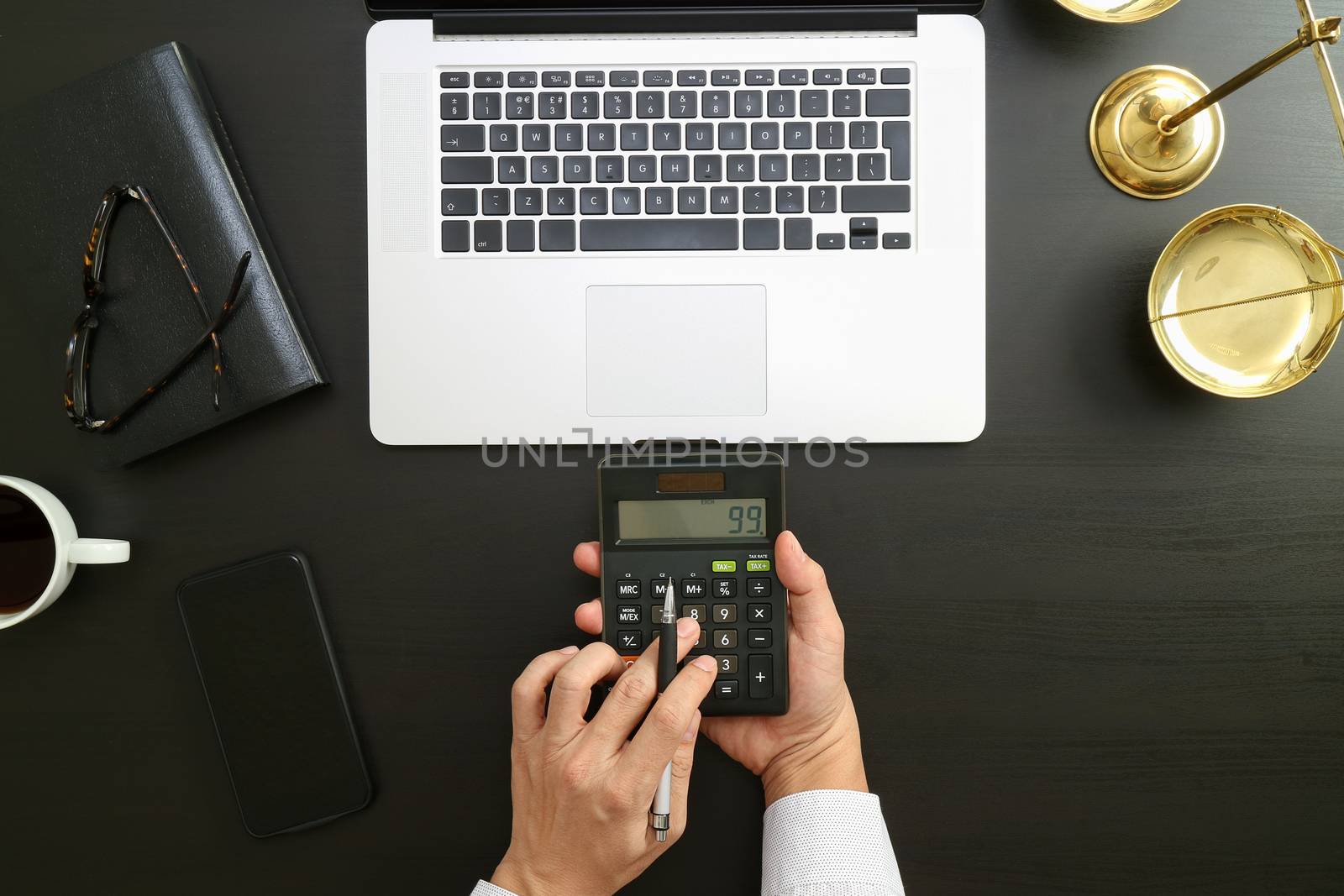 justice and law concept.businessman or lawyer or accountant working on accounts using a calculator and laptop computer and documents in modern office