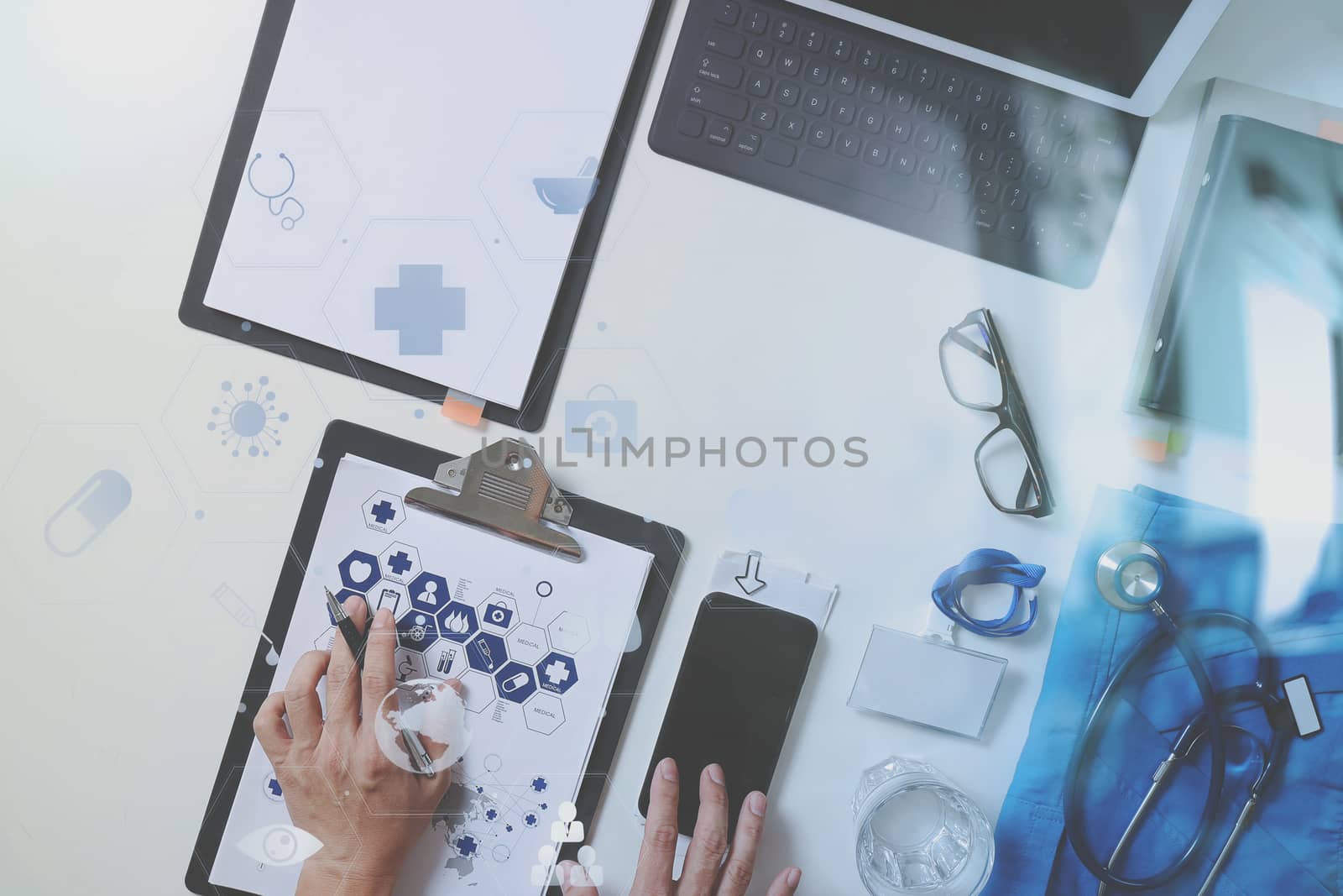 top view of smart medical doctor working with mobile phone and laptop computer and stethoscope on dark wooden desk with virtual reality icon diagram 