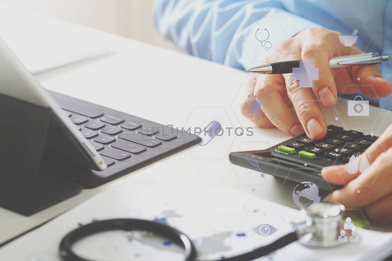 Healthcare costs and fees concept.Hand of smart doctor used a calculator for medical costs in modern hospital with VR icon diagram