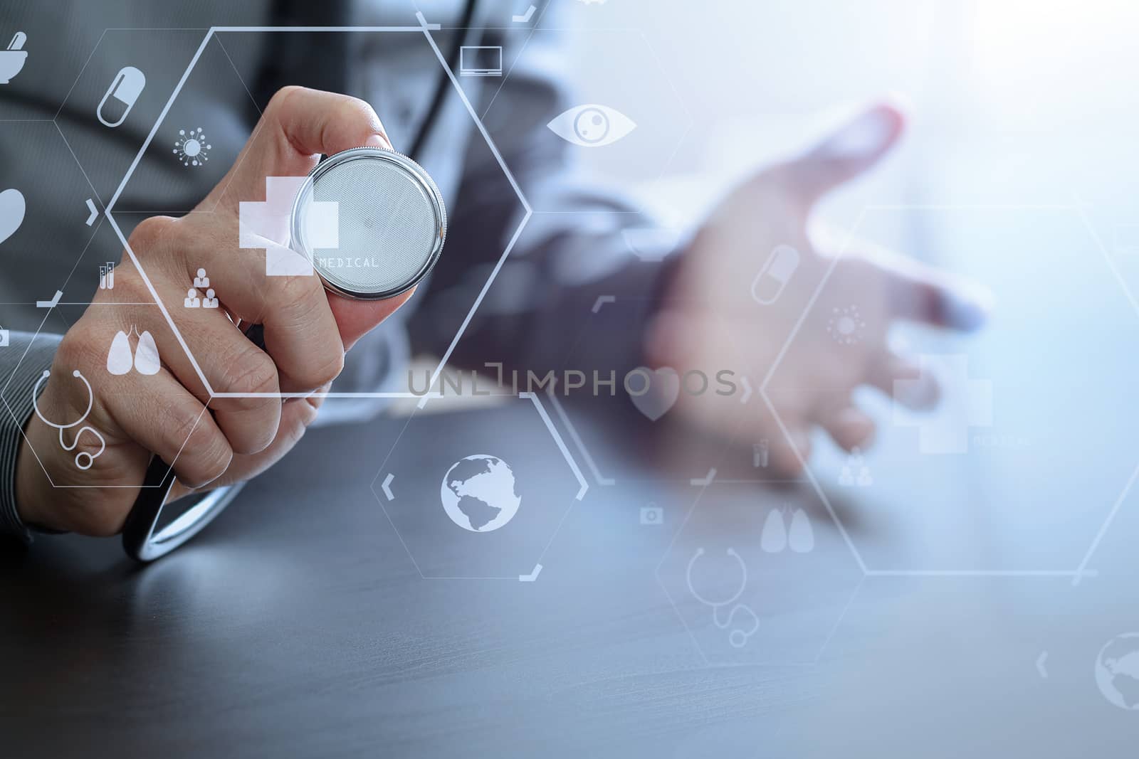 close up of smart medical doctor working with stethoscope on dark wooden desk in modern hospital with virtual reality icon diagram 