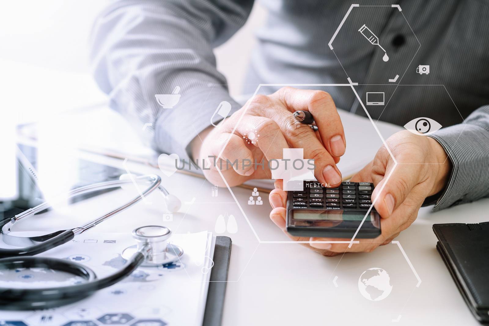 Healthcare costs and fees concept.Hand of smart doctor used a calculator for medical costs in modern hospital with VR icon diagram