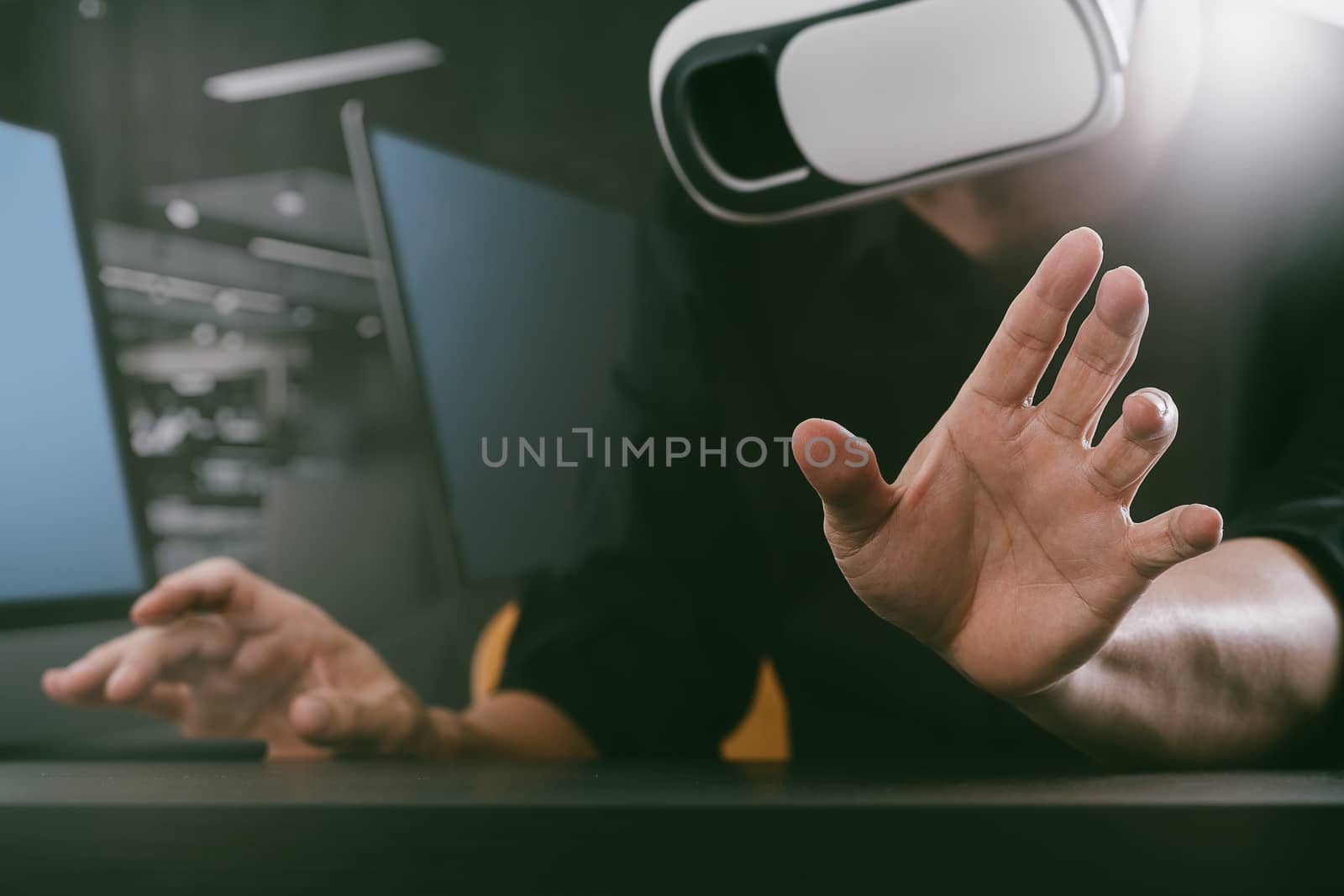 businessman wearing virtual reality goggles in modern office with mobile phone using with VR headset 