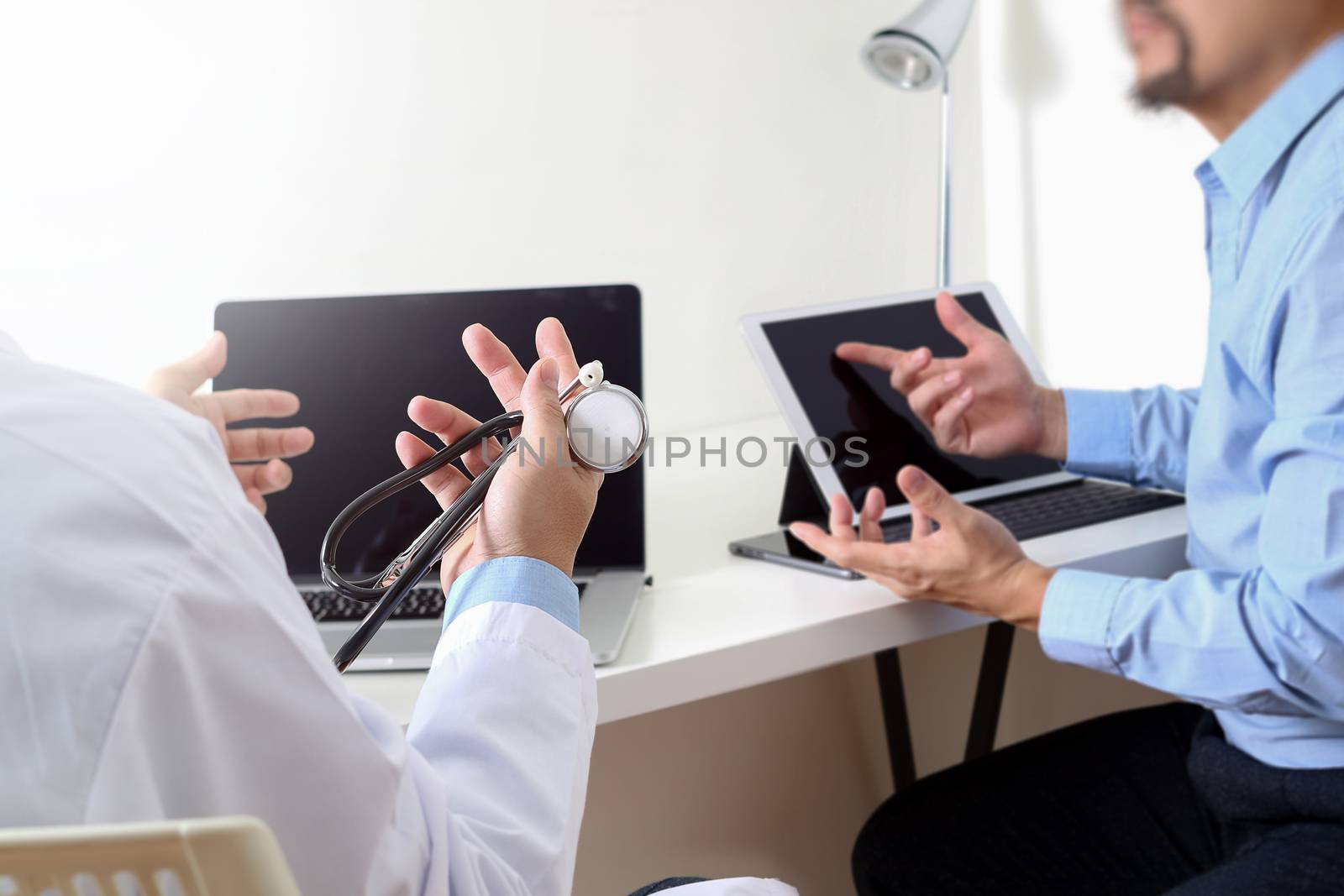 Medical doctor in white uniform gown coat consulting businessman patient having exam as Hospital professionalism concept 