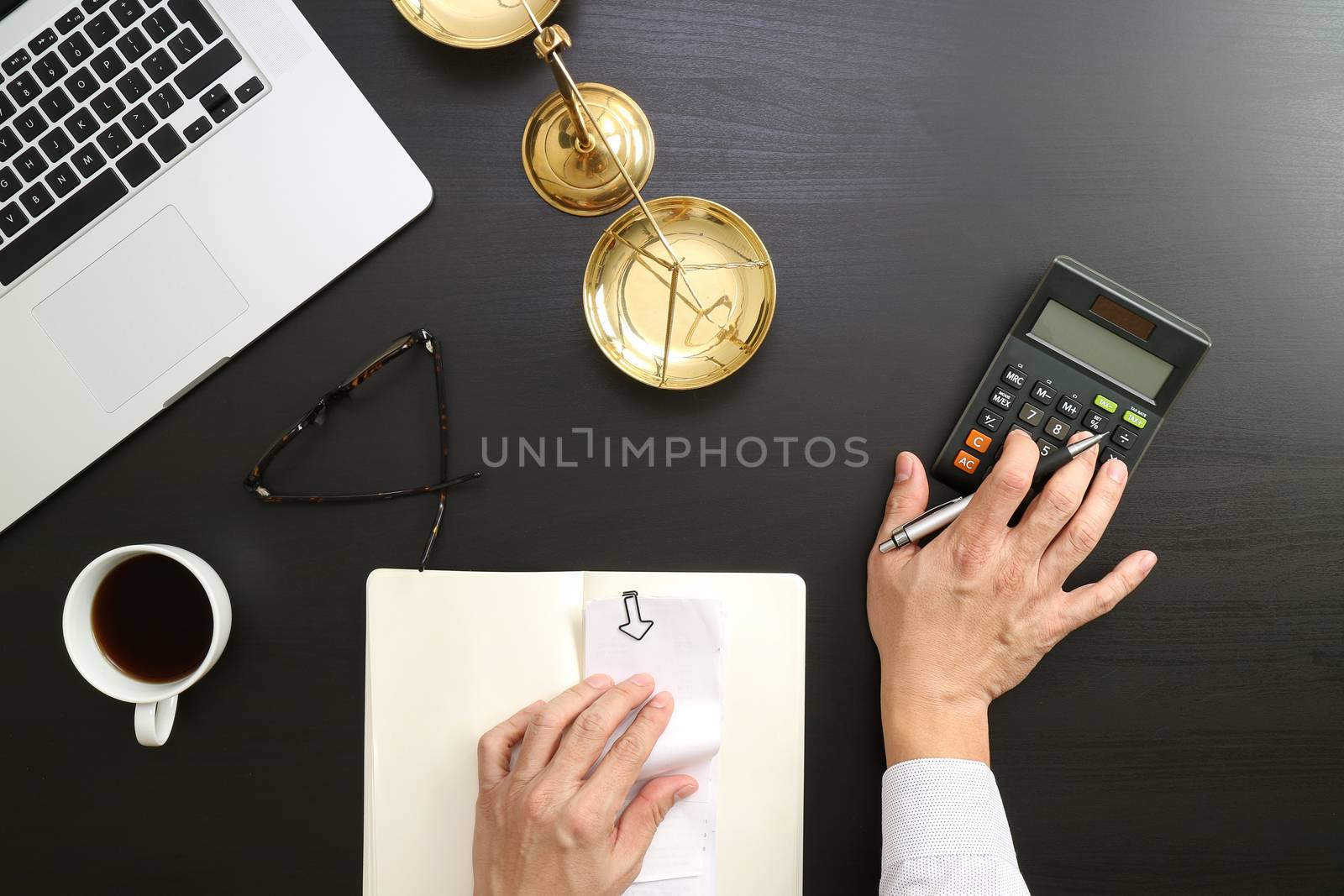 justice and law concept.businessman or lawyer or accountant working on accounts using a calculator and laptop computer and documents in modern office