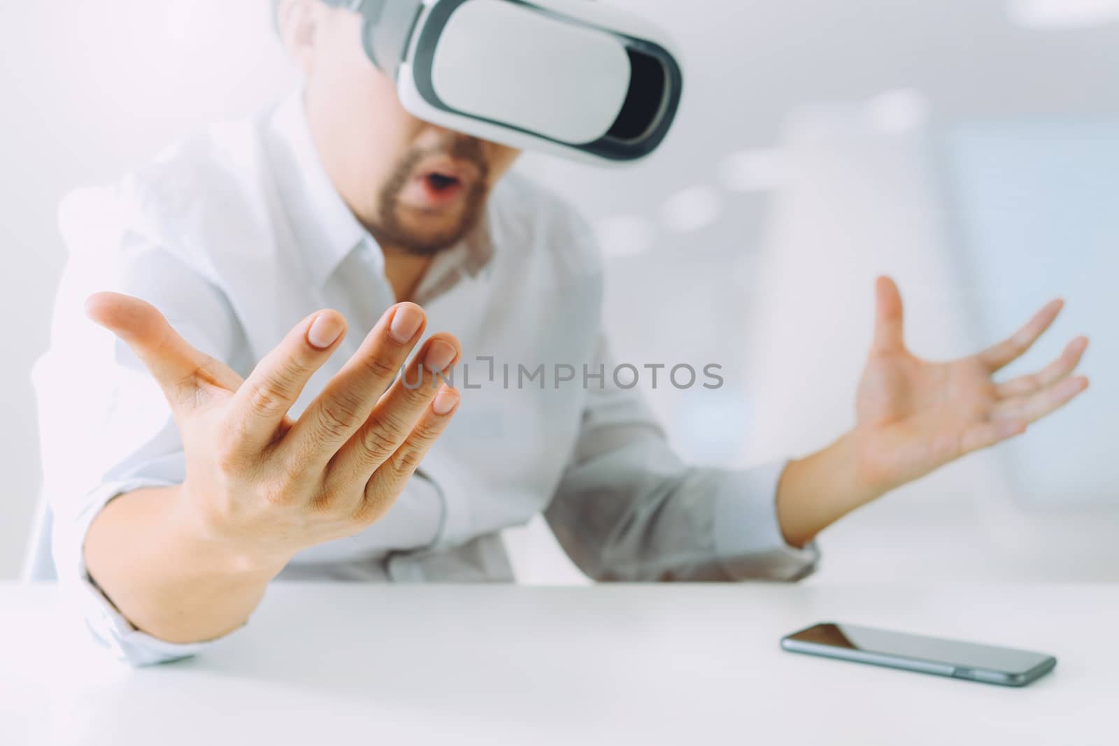 businessman wearing virtual reality goggles in modern office wit by everythingpossible