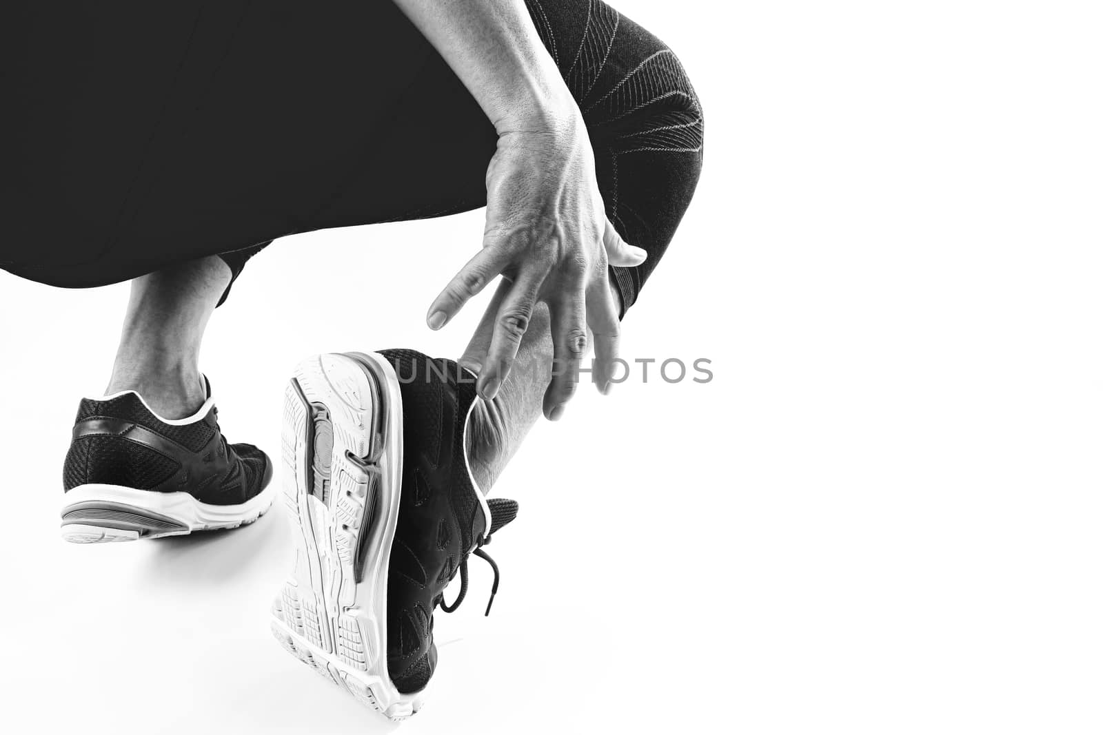 Runner sportsman holding ankle in pain with Broken twisted joint running sport injury and Athletic man touching foot due to sprain on white background