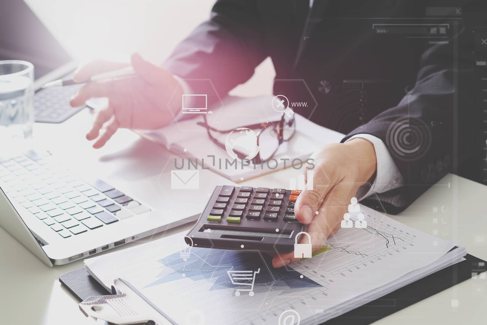 businessman hand working with finances about cost and calculator  and latop with mobile phone on withe desk in modern office with VR icon diagram