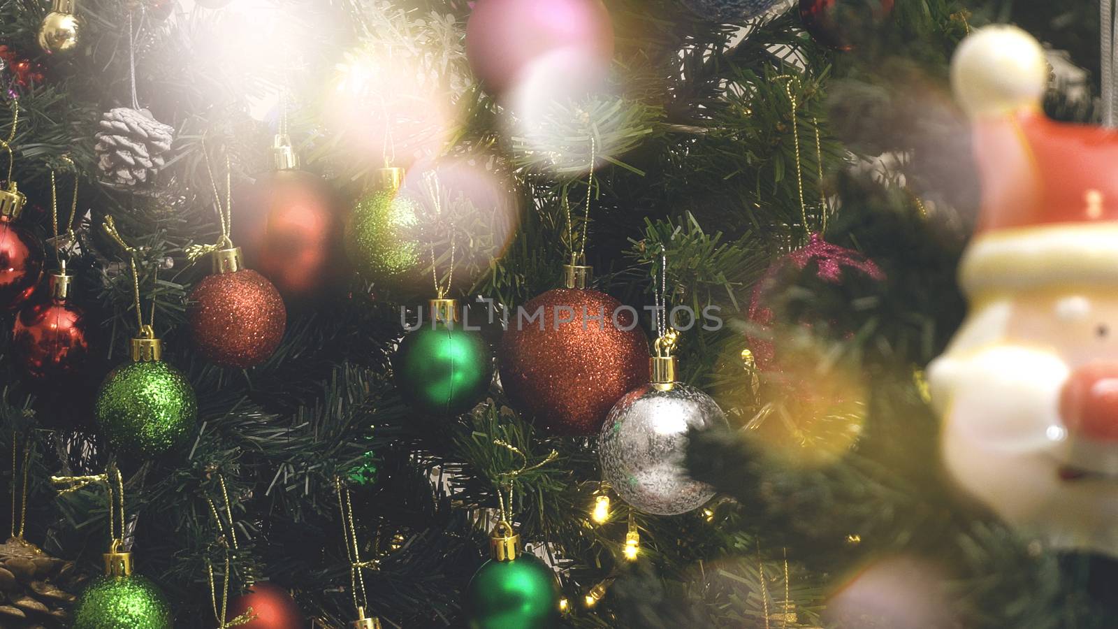 Greeting Season concept.close up of ornaments on a Christmas tree with decorative light