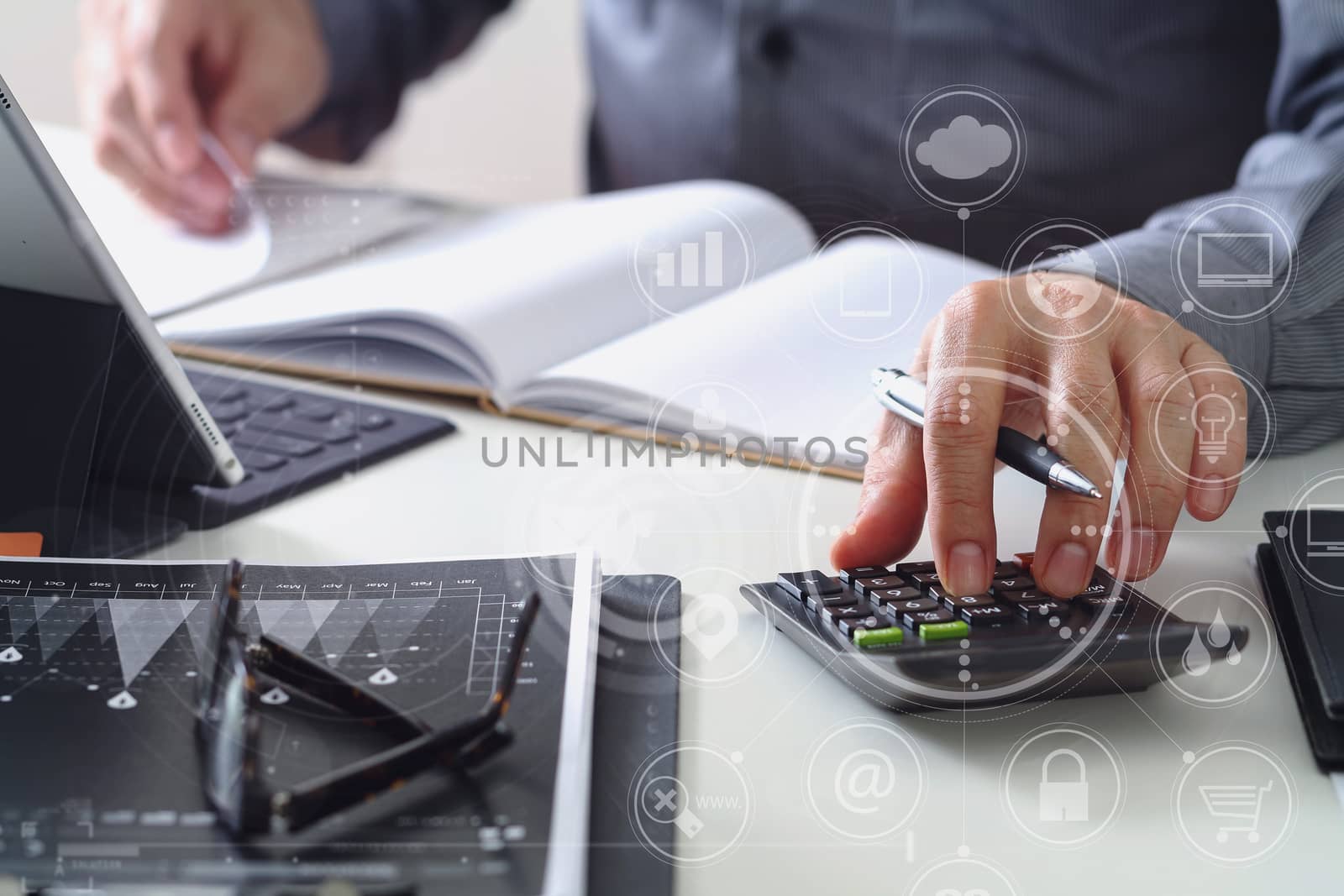 businessman hand working with finances about cost and calculator and latop with mobile phone on withe desk in modern office with VR icon diagram