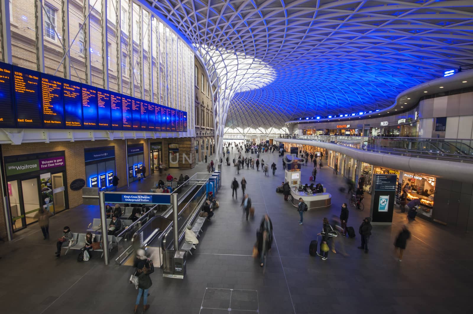 LONDON, ENGLAND - FEBRUARY 3RD 2015:  London commuters travel through Kings Cross train station on February 3rd 2015. London commuters recently said they were unhappy in a recent survey on train travel.