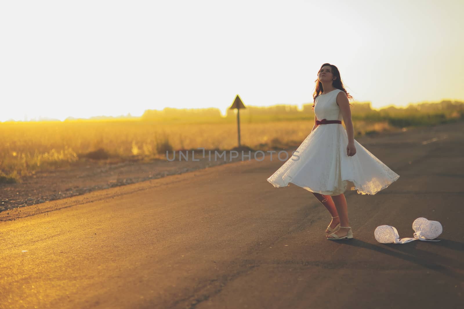 Beautiful girl dancing in a park in the sunset light. Happiness concept. High quality photo