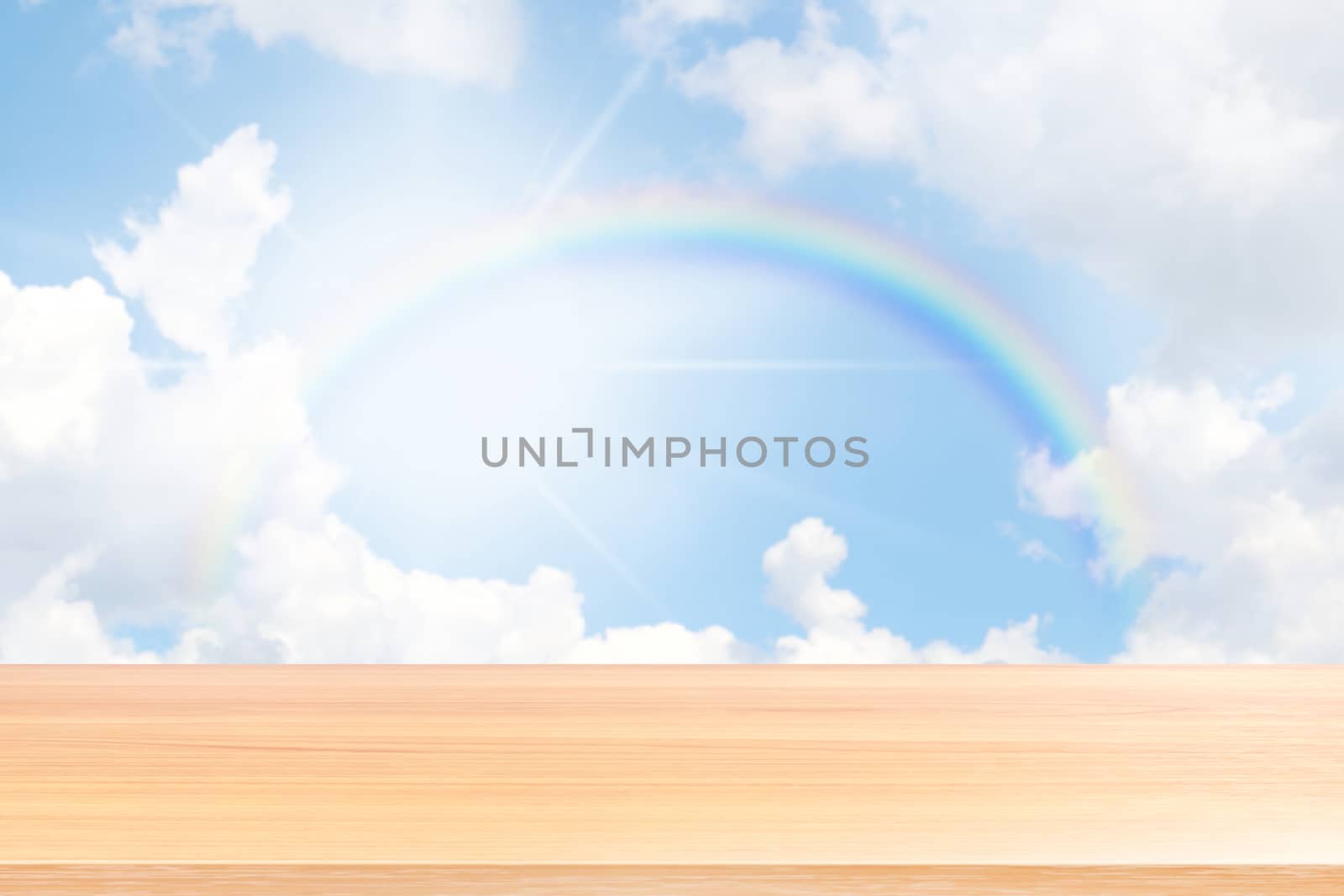 empty wood table floors on rainbow and blue sky background, wood table board empty front rainbows rings circle on sky, wooden plank blank over colorful rainbow in the sky for mock up display products