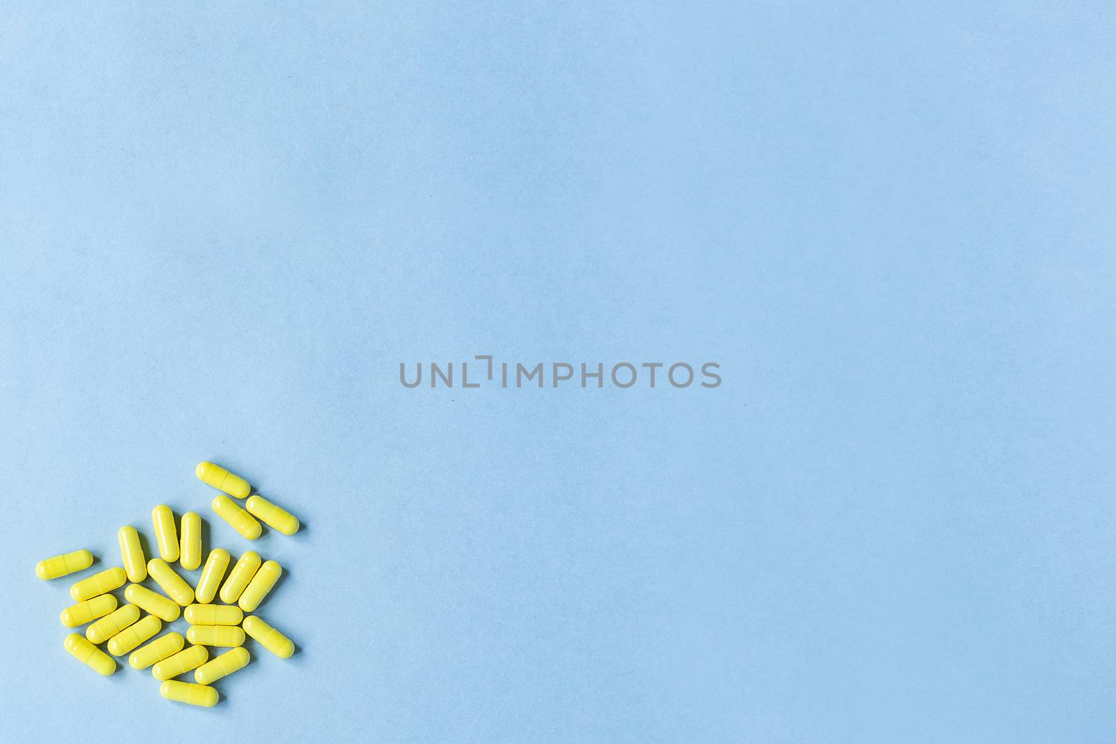 Yellow capsules on a blue background. Omega-3 vitamins. food Supplement. Fish oil in capsules. Free space. copy space. space for text. blurred background. Selective focus. banner. concept of medicine. by Pirlik