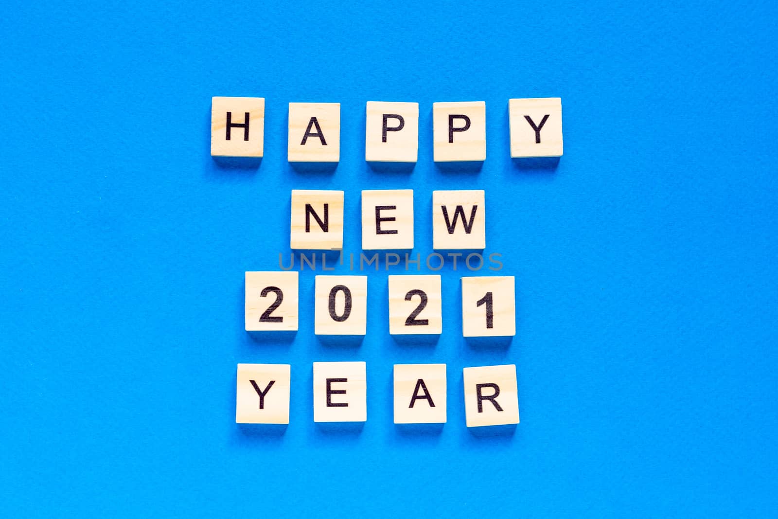 Happy New year written in wooden letters on a blue background. Happy new year 2021. flat layout. space for text. top view. by Pirlik