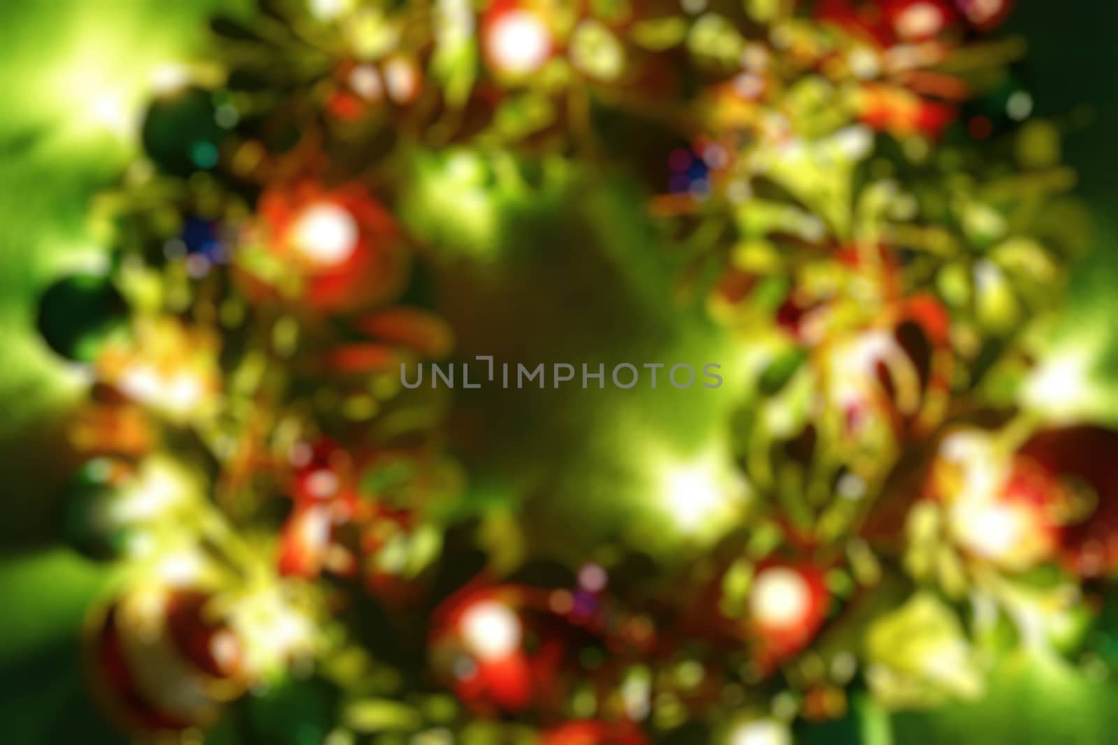 Greeting Season concept.Blur Christmas wreath with decorative light on dark wood background