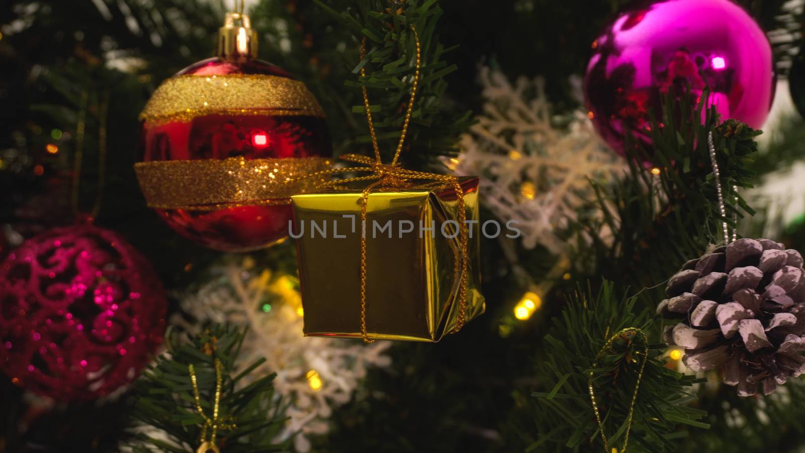 Greeting Season concept.close up of ornaments on a Christmas tree with decorative light