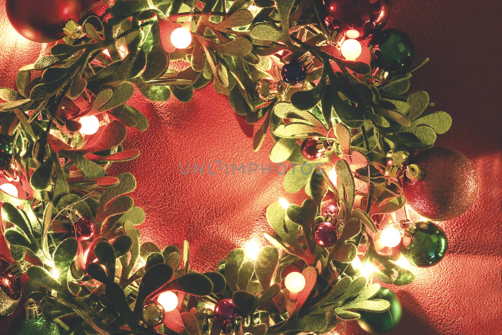 Greeting Season concept.Christmas wreath with decorative light on red background