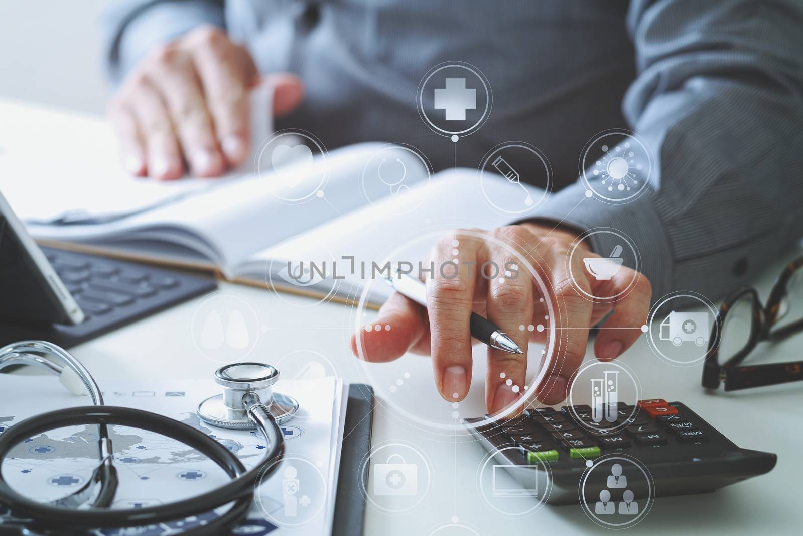 Healthcare costs and fees concept.Hand of smart doctor used a calculator for medical costs in modern hospital with VR icon diagram