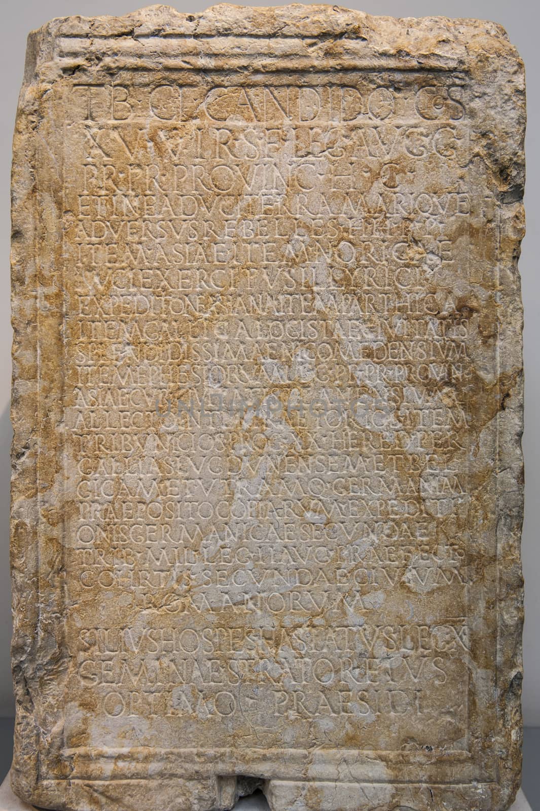 Ancient carved greek stone tablet with inscriptions on display in museum