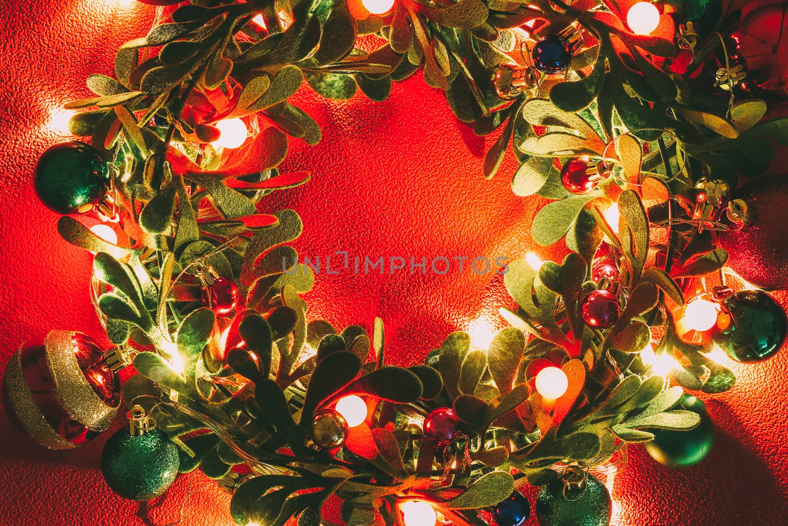 Greeting Season concept.Christmas wreath with decorative light on red background