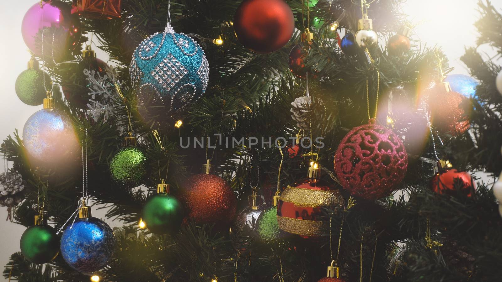 Greeting Season concept.close up of ornaments on a Christmas tree with decorative light