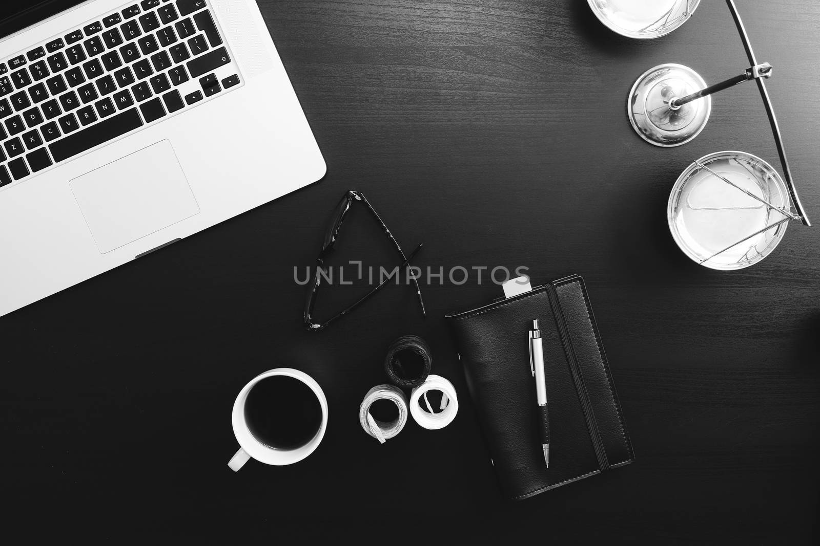 justice and law concept.Lawyer workplace with laptop and documents with dark wooden,black and white