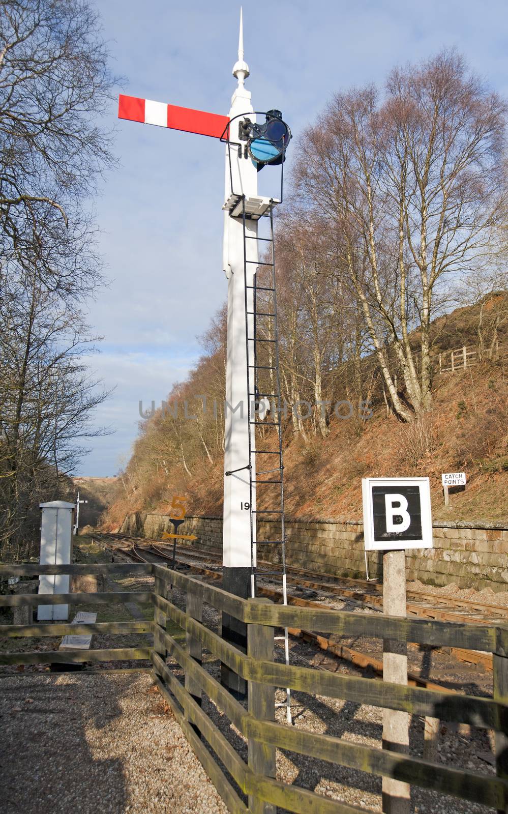 Old traditional railway signal at a points junction in the countryside