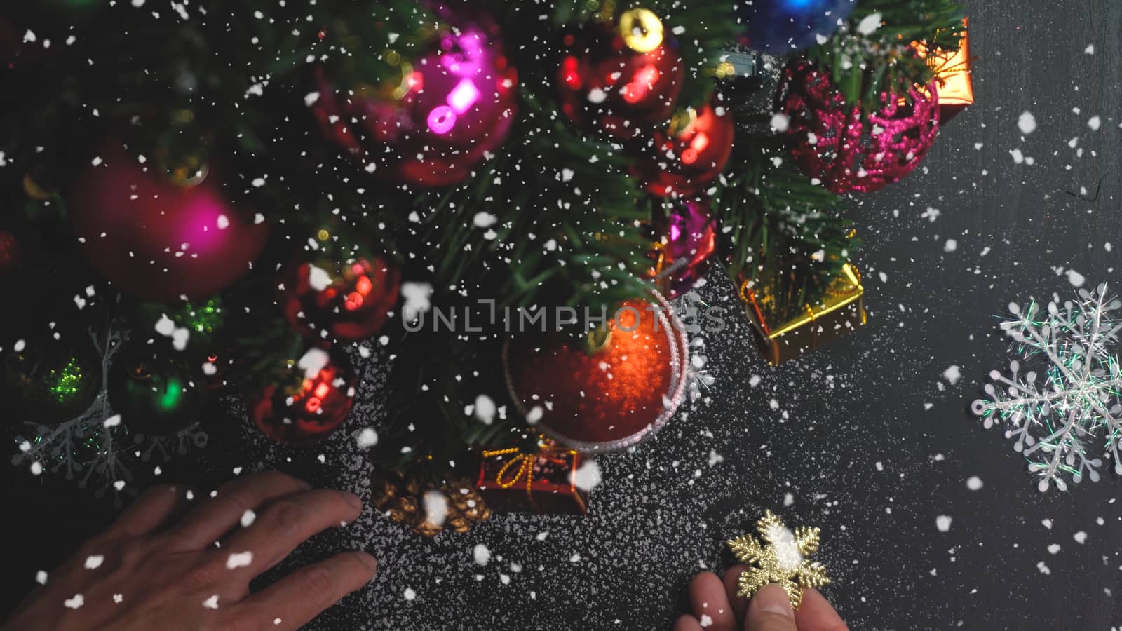 Greeting Season concept.hand setting of ornaments on a Christmas tree with decorative light