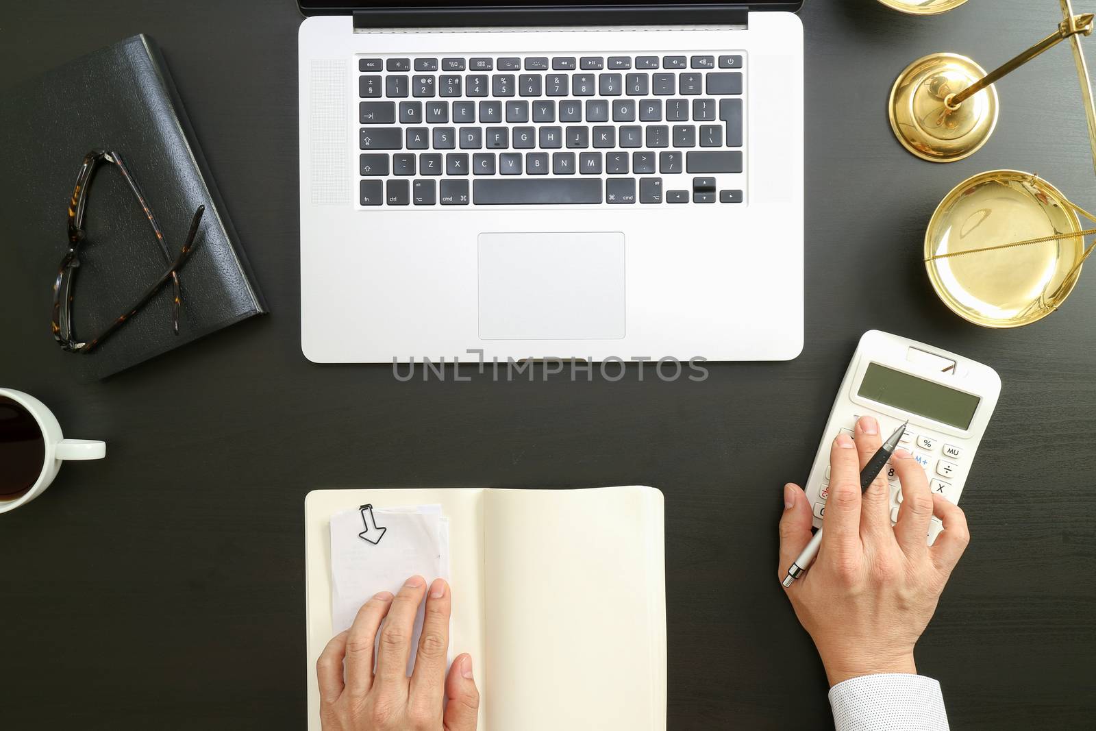 justice and law concept.businessman or lawyer or accountant working on accounts using a calculator and laptop computer and documents in modern office