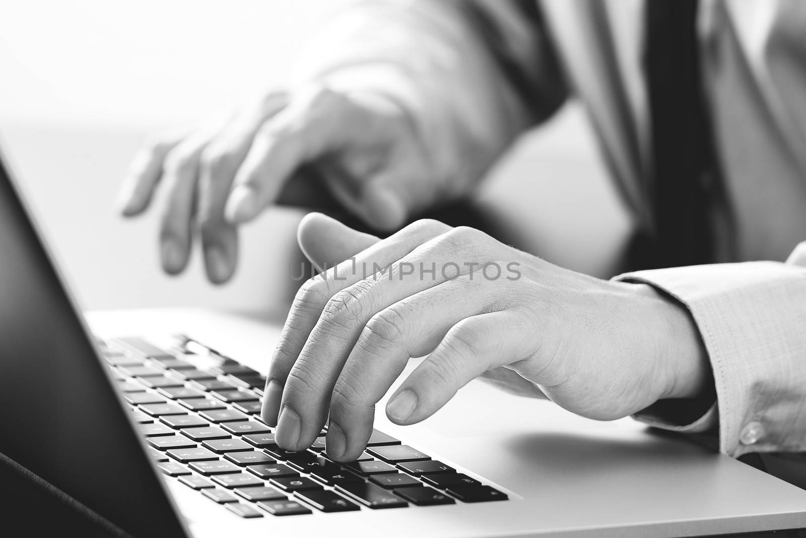 close up of businessman typing keyboard with laptop computer on wooden desk in modern office with virtual reality icon diagram   