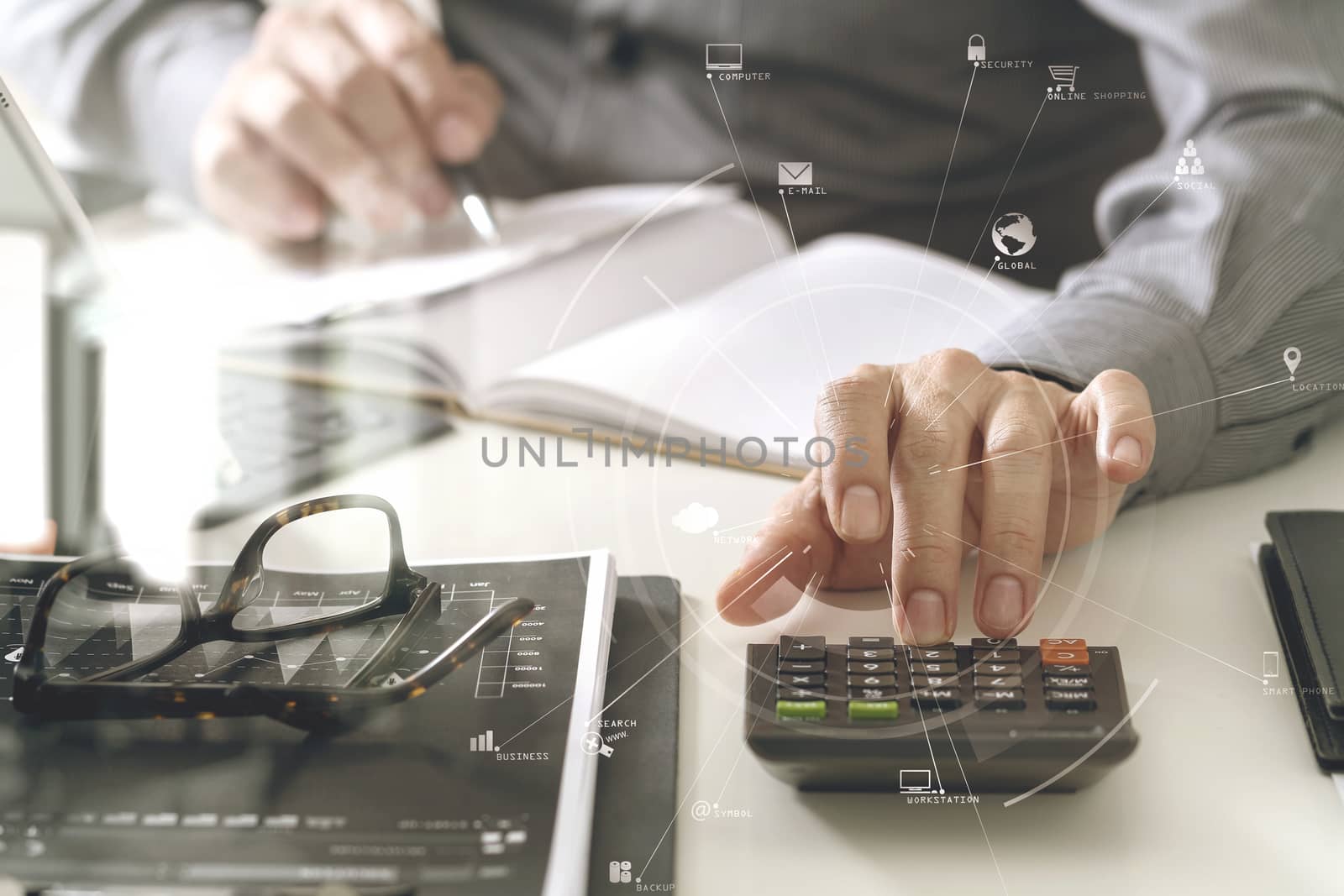 businessman hand working with finances about cost and calculator and latop with mobile phone on withe desk in modern office with VR icon diagram