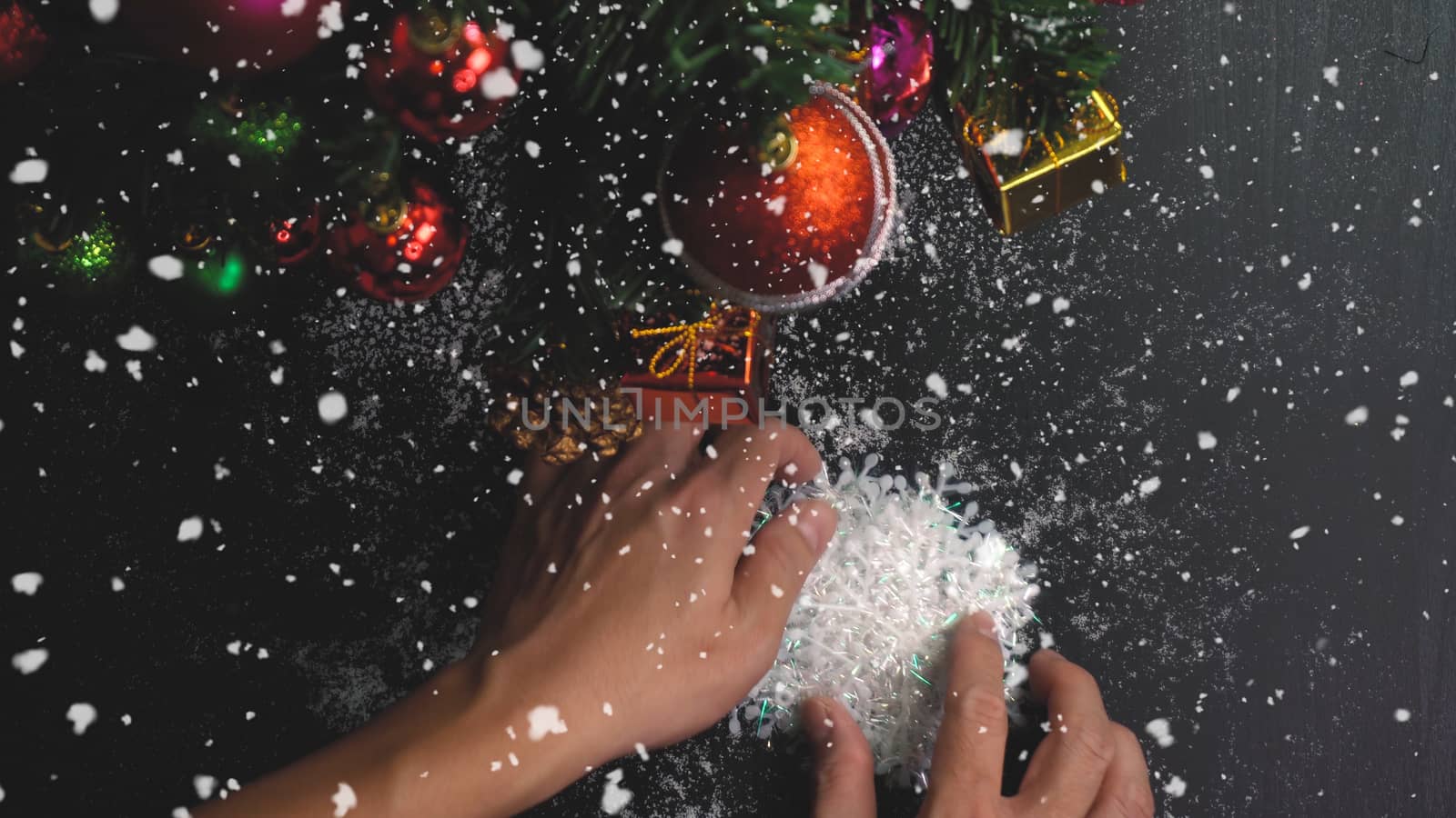 Greeting Season concept.hand setting of ornaments on a Christmas tree with decorative light