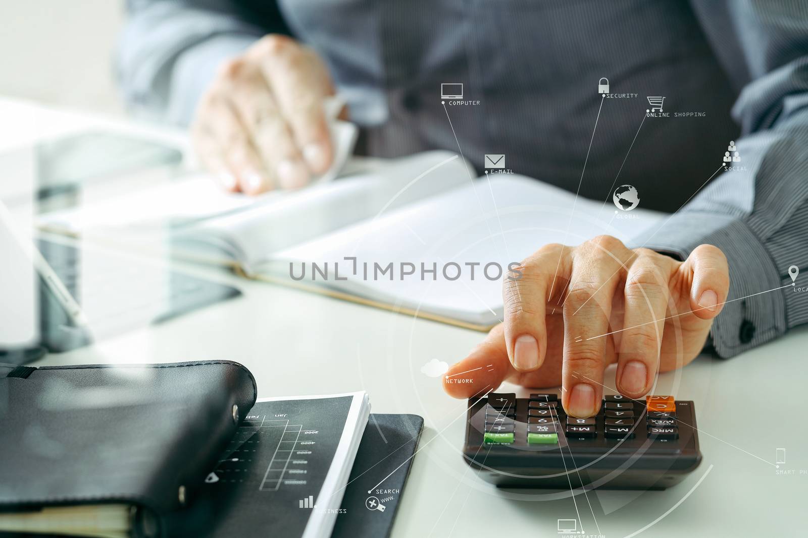 businessman hand working with finances about cost and calculator and latop with mobile phone on withe desk in modern office with VR icon diagram