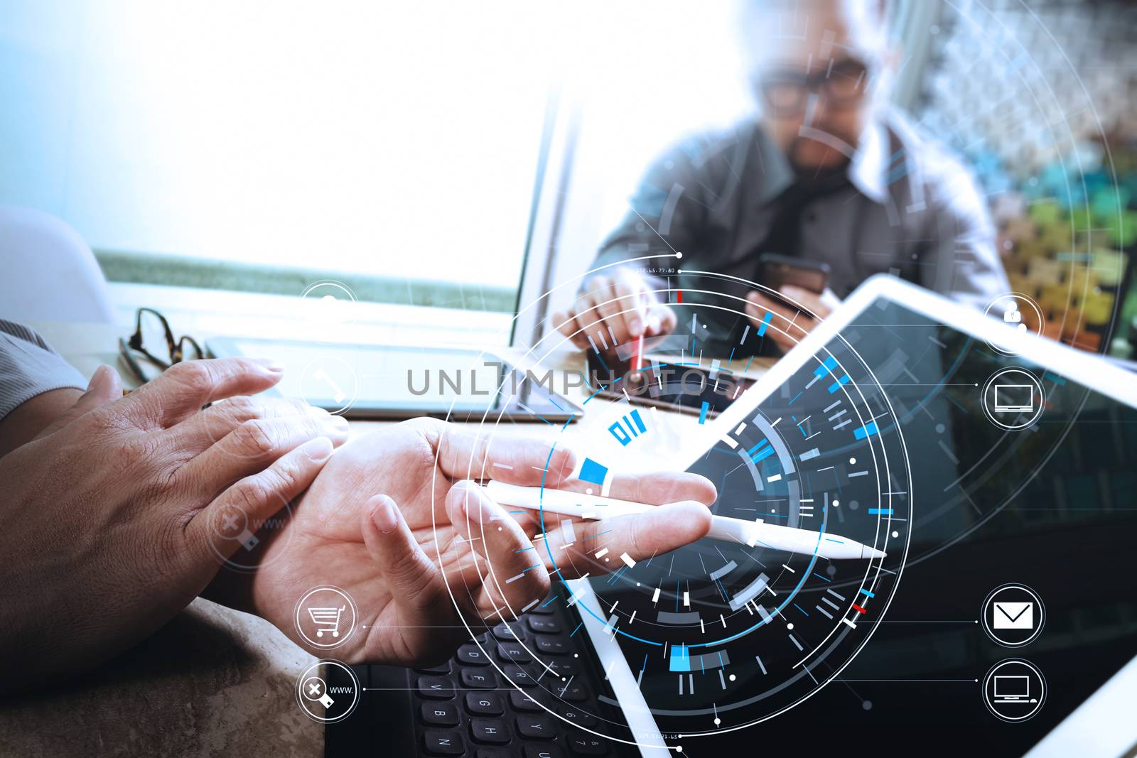 Businessmen working together on a document and using smart phone and digital tablet and laptop computer in modern office with VR icon diagram                                                              